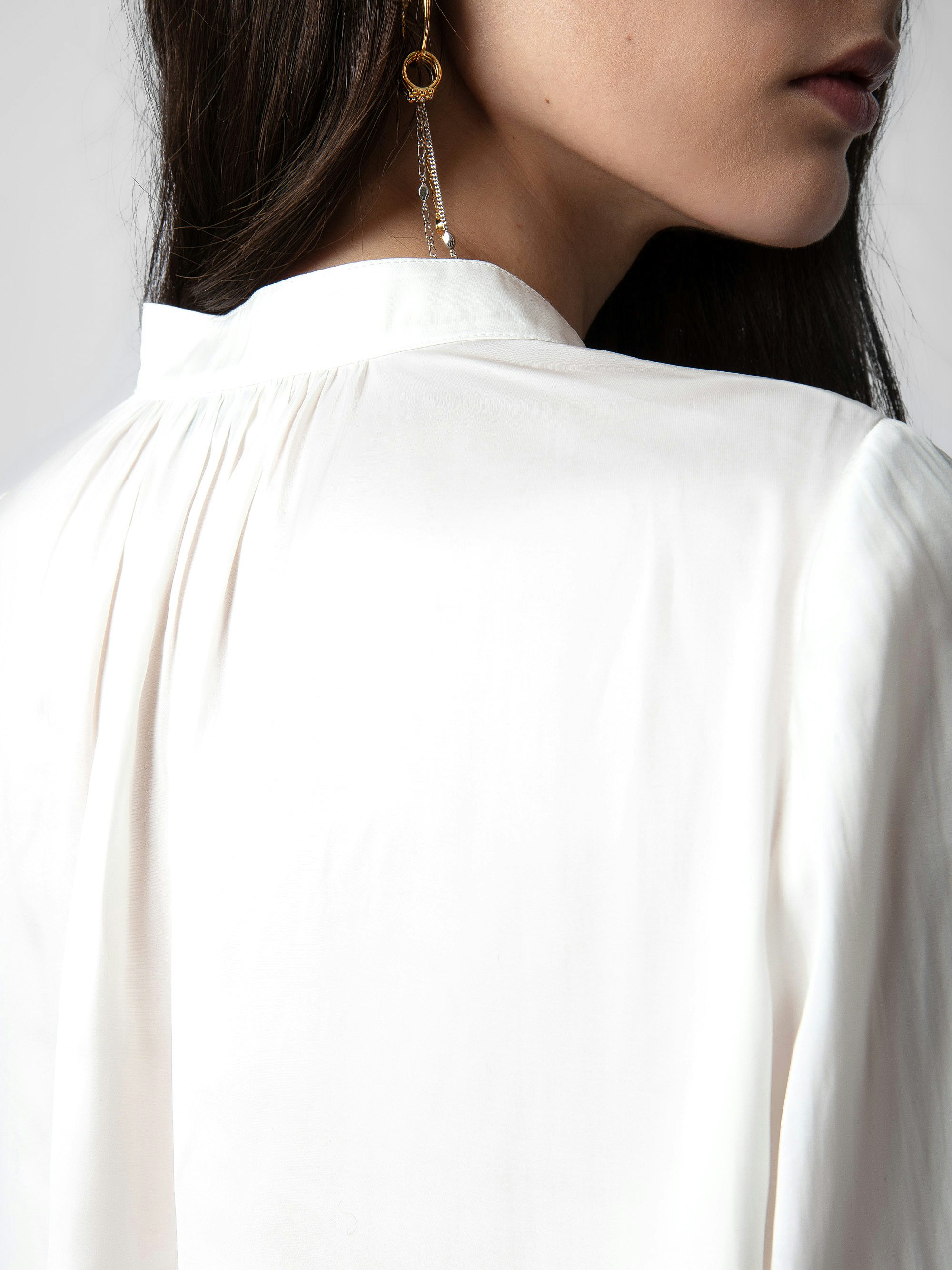 Tink Satin Blouse - Open-collar satin blouse with long sleeves and gathered details.